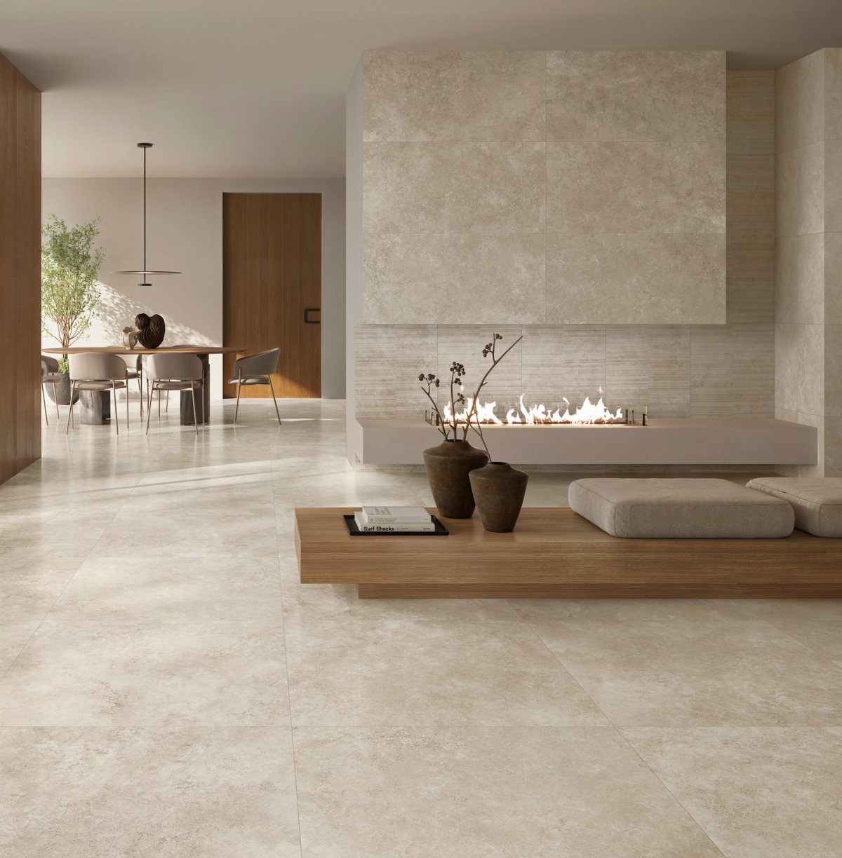 Large beige stone tiles covering the floor and a textured tile wall above a modern fireplace.