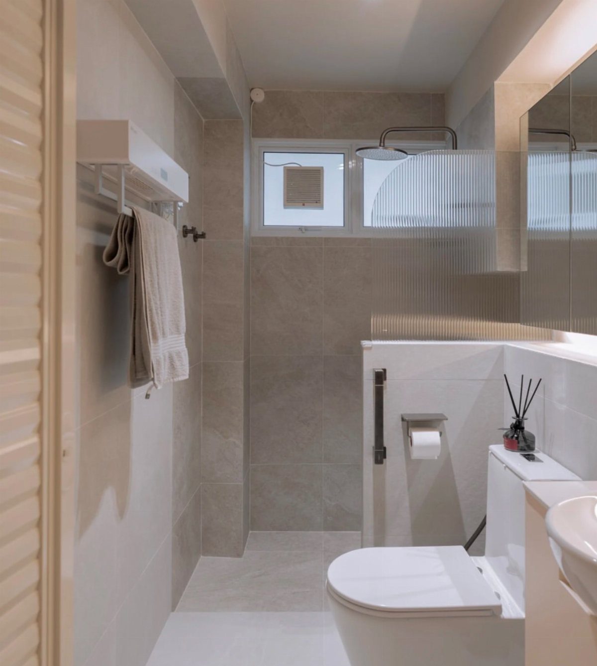 Small modern bathroom featuring a white toilet and a window with a ventilation vent.