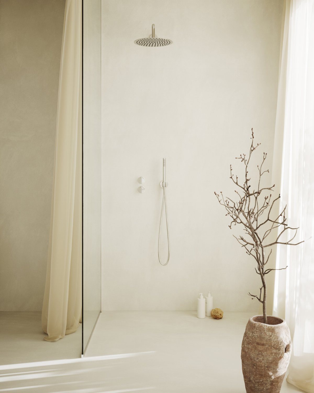 Minimalist cream bathroom featuring a walk-in shower, silver fixtures, and a large vase with branches.